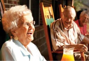 HRA Partners - Elderly friends laughing on the porch.